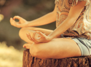 Young female meditate in nature